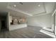 Spacious open-concept living area with recessed lighting and modern gray wood flooring at 1495 Craleigh St, North Port, FL 34288