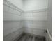 Walk-in pantry with ample shelving for organized storage and gray wood floors at 1495 Craleigh St, North Port, FL 34288