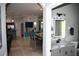 Bathroom featuring a modern vanity and mirror, adjacent to the dining area and partial view of the living room at 1884 Coconut Palm Cir, North Port, FL 34288