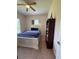 Bedroom with a ceiling fan, carpeted floor, and a white framed bed with dark blue accents at 1884 Coconut Palm Cir, North Port, FL 34288