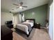 Primary bedroom features green accent wall, ceiling fan and dresser at 1884 Coconut Palm Cir, North Port, FL 34288