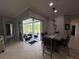 Dining area with a large table next to a lanai featuring outdoor seating and views of the yard at 1884 Coconut Palm Cir, North Port, FL 34288