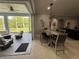 Dining area next to a screened lanai with outdoor seating and adjacent to the living area at 1884 Coconut Palm Cir, North Port, FL 34288