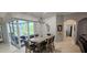 Bright dining area featuring sliding doors to the lanai, stylish light fixture, and tile flooring throughout at 1884 Coconut Palm Cir, North Port, FL 34288