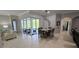 Elegant dining room with stylish light fixture and access to the screened lanai for indoor/outdoor living at 1884 Coconut Palm Cir, North Port, FL 34288