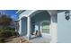 Inviting front porch with decorative columns and textured walls creating a charming entrance at 1884 Coconut Palm Cir, North Port, FL 34288