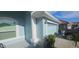 Side view of a two-car garage showcasing the home's architectural details and ample parking space at 1884 Coconut Palm Cir, North Port, FL 34288