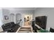 Comfortable living room setup featuring tile floors, modern entertainment system, and doorway to a separate office area at 1884 Coconut Palm Cir, North Port, FL 34288