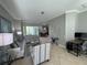 Spacious living room with a tile floor, gray walls, and comfortable seating arrangement at 1884 Coconut Palm Cir, North Port, FL 34288