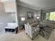 Bright and airy living room featuring neutral tones, stylish furniture, and ample natural light at 1884 Coconut Palm Cir, North Port, FL 34288