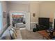 View of living room leading to kitchen with stainless steel appliances and a two-seat island bar at 1884 Coconut Palm Cir, North Port, FL 34288