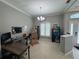 Versatile office featuring a modern desk, ample storage, and abundant natural light through shuttered windows at 1884 Coconut Palm Cir, North Port, FL 34288