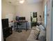 Well-lit home office featuring neutral paint, carpet flooring, and doorway leading to another room at 1884 Coconut Palm Cir, North Port, FL 34288