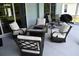 Stylish patio area with modern seating around a fire pit, perfect for outdoor entertaining at 1884 Coconut Palm Cir, North Port, FL 34288