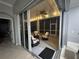 Enclosed porch with outdoor seating, fan, and outdoor string lights, creating a serene ambiance at 1884 Coconut Palm Cir, North Port, FL 34288