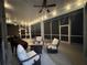 Cozy screened-in patio featuring comfortable seating, a fire pit, and soft string lights, perfect for relaxation at 1884 Coconut Palm Cir, North Port, FL 34288