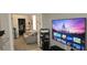 Bright sitting area with a large-screen television and doorway to a separate home office space at 1884 Coconut Palm Cir, North Port, FL 34288