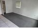 Carpeted bedroom features neutral paint, a window with blinds, and a closet for convenient storage at 2308 18Th E St, Bradenton, FL 34208