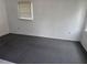 A well-lit bedroom features neutral gray carpet and a window with blinds at 2308 18Th E St, Bradenton, FL 34208
