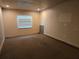 Bedroom with neutral carpet, window providing natural light, and spacious layout for various furniture arrangements at 2308 18Th E St, Bradenton, FL 34208