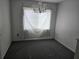 Bright dining room featuring neutral carpet, chandelier lighting, and a window with privacy treatment at 2308 18Th E St, Bradenton, FL 34208