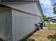 Exterior view of the home, showcasing the vinyl siding and a metal chain link fence at 2308 18Th E St, Bradenton, FL 34208