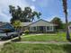 Charming home with a stone facade, complemented by a well-manicured lawn and a truck parked in the driveway at 2308 18Th E St, Bradenton, FL 34208