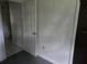 A look at a hall with tile flooring, leading to a bedroom area with gray carpeting at 2308 18Th E St, Bradenton, FL 34208