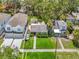 Aerial view of a single Gathering residence featuring a well-maintained lawn, detached garage, and lush trees at 2710 W North A St, Tampa, FL 33609