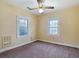 Bright bedroom featuring two windows, a ceiling fan and a heater at 2710 W North A St, Tampa, FL 33609