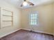 Bedroom featuring neutral carpet, a built-in bookcase, and plenty of natural light from the window at 2710 W North A St, Tampa, FL 33609