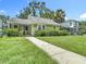 Charming single Gathering home with a green lawn, walkway, and lush green shrubbery at 2710 W North A St, Tampa, FL 33609