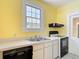 Kitchen featuring white cabinets, an oven, and stainless steel sink underneath a window at 2710 W North A St, Tampa, FL 33609