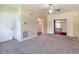 Spacious living room with carpet flooring and a ceiling fan, features a doorway to another room at 2710 W North A St, Tampa, FL 33609