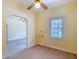 Bright living room featuring a ceiling fan, window, and arched doorway leading to another room at 2710 W North A St, Tampa, FL 33609