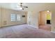 Living room features textured walls, a ceiling fan, and an open doorway to other rooms at 2710 W North A St, Tampa, FL 33609