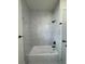 Stylish bathroom featuring modern fixtures, bathtub and white marble tile shower at 16475 Hillsborough Blvd, Port Charlotte, FL 33954