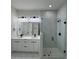 This modern bathroom features a double vanity, a walk-in shower, and elegant fixtures at 16475 Hillsborough Blvd, Port Charlotte, FL 33954