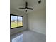 Bedroom with marble floors and white paint. Black trimming for the windows and a ceiling fan at 16475 Hillsborough Blvd, Port Charlotte, FL 33954