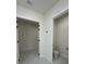 Hallway that leads to the bathroom and the closet. The interior has white paint and marble floors at 16475 Hillsborough Blvd, Port Charlotte, FL 33954