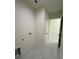 The laundry room has marble floors with white paint. There is a door leading to the next room at 16475 Hillsborough Blvd, Port Charlotte, FL 33954