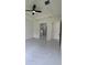 Bright and airy main bedroom featuring a ceiling fan and a door leading to the bathroom at 16475 Hillsborough Blvd, Port Charlotte, FL 33954