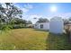 Large backyard featuring a storage shed and a well-maintained lawn at 1740 Lucas Dr, Clearwater, FL 33759