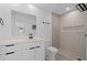 Well-lit bathroom with white vanity, patterned shower tiles, and modern fixtures at 1740 Lucas Dr, Clearwater, FL 33759