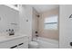 Modern bathroom showcasing a white vanity, updated fixtures, and a tiled shower/tub combo at 1740 Lucas Dr, Clearwater, FL 33759