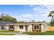 Inviting single-story home with a well-manicured lawn, updated windows, and a cozy, suburban feel at 1740 Lucas Dr, Clearwater, FL 33759