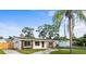 Well-kept single-story home with a spacious yard, updated windows, and complemented by mature trees at 1740 Lucas Dr, Clearwater, FL 33759