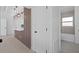 Hallway view showcases modern lighting, neutral paint, leading to bathroom and an open-concept kitchen at 1740 Lucas Dr, Clearwater, FL 33759