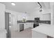 Beautiful kitchen with stainless appliances, white cabinets, tile backsplash, and bright lighting at 1740 Lucas Dr, Clearwater, FL 33759