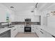 Bright kitchen features white cabinetry, stainless steel appliances, and modern finishes at 1740 Lucas Dr, Clearwater, FL 33759